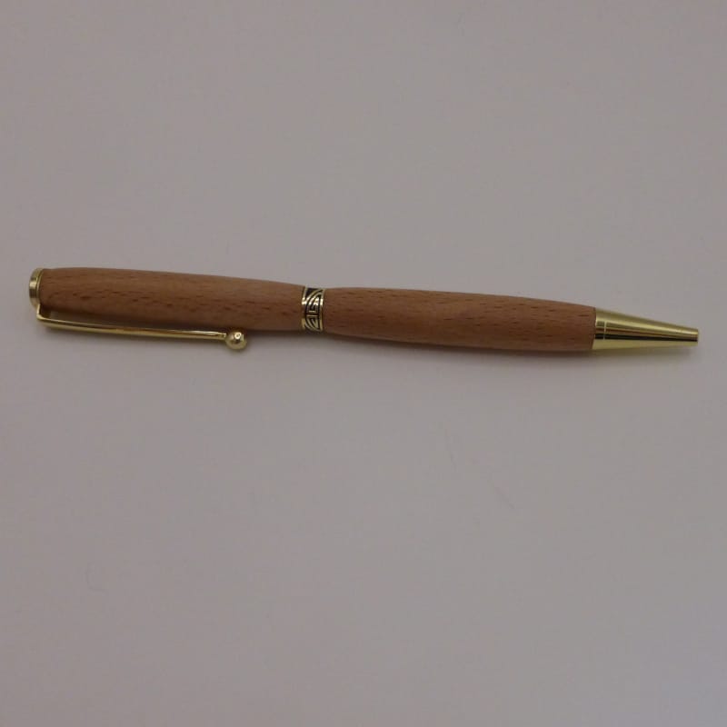 Stylo bille Inspiration en bois de hêtre avec une bague décorative et un mécanisme plaqué or. Sa forme est fine.